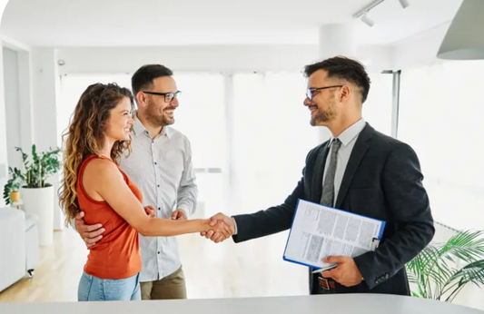 "Real estate agent meeting with clients at a home, discussing property details and buying options"